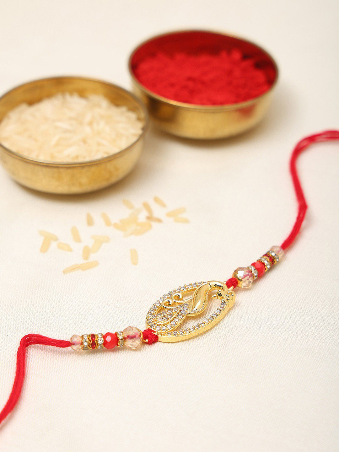 Exotic India Oval Shaped Stone Studded & Beaded Peacock Thread Rakhi