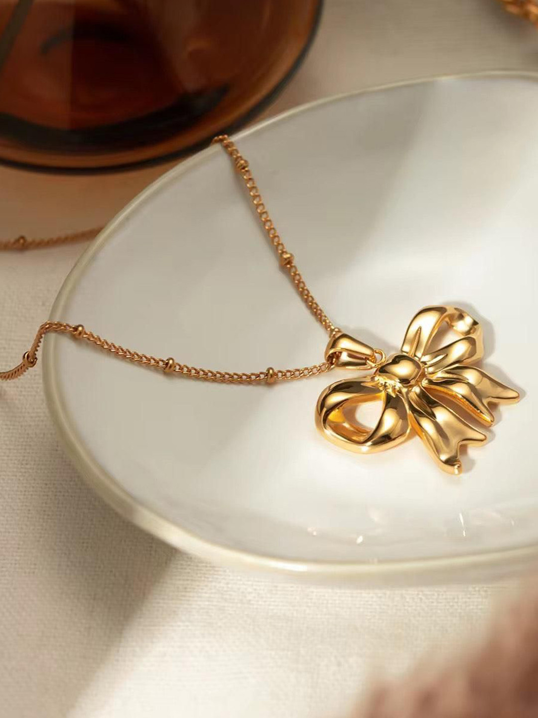 THEPANDASTOREE Gold-Toned Stainless Steel Pendant Necklace with Ribbon Design