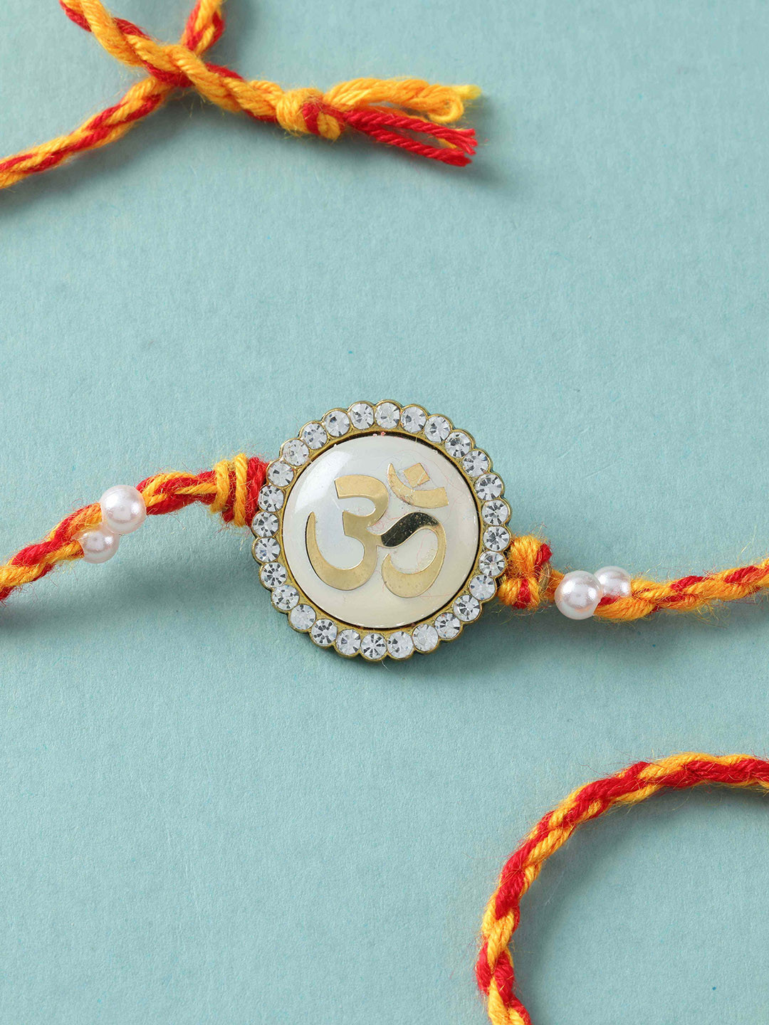 fnp Artificial Stones Studded And Beaded Om Sacred Thread Rakhi