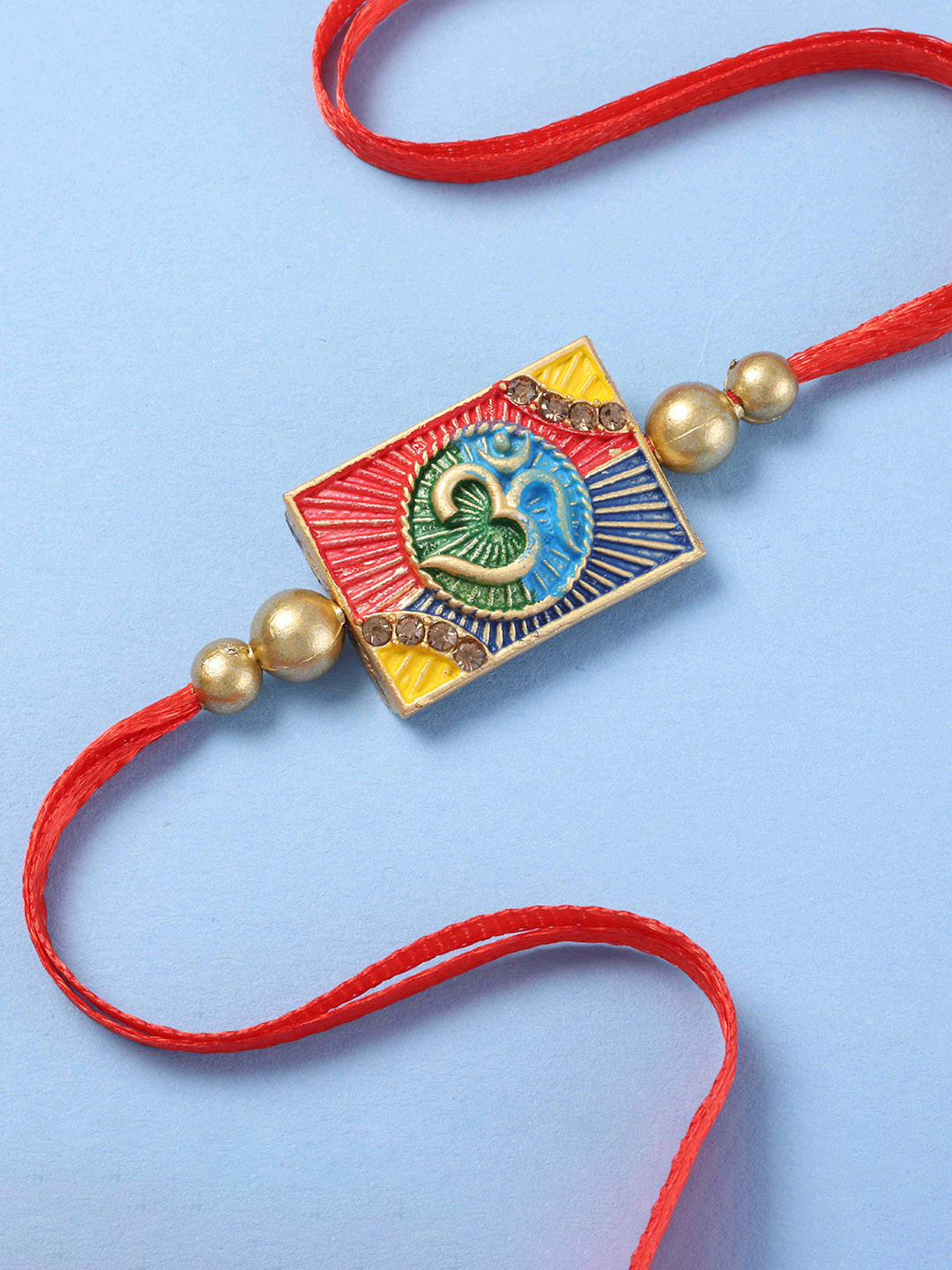fnp Stones Studded Enamelled Om Thread Rakhi