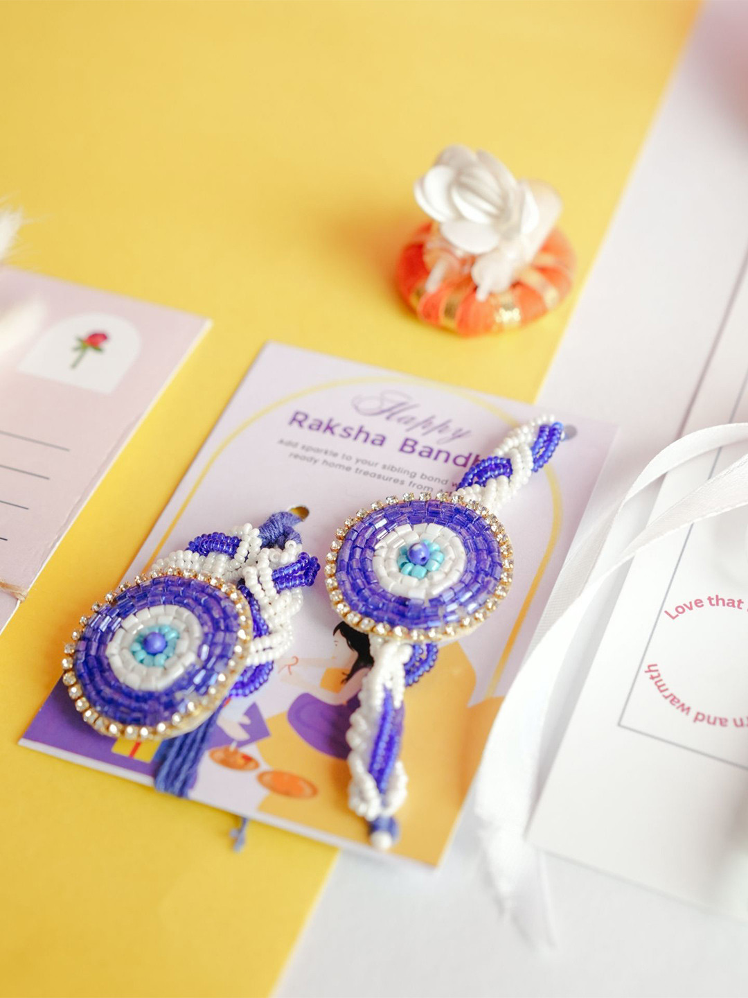 ArteCasa 2-Pcs Rakhi With Flower With Greeting Card & Roli Chawal