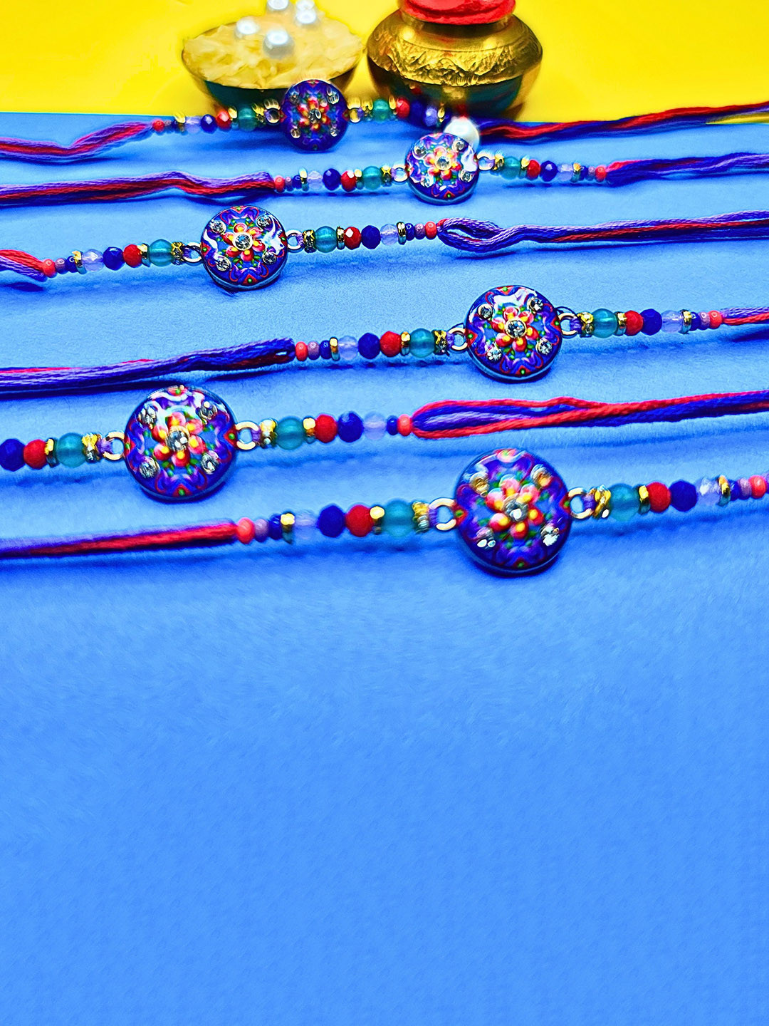ORANGENYSHA Set Of 6 Beaded Cotton Thread Rakhis With Rholi Chawal