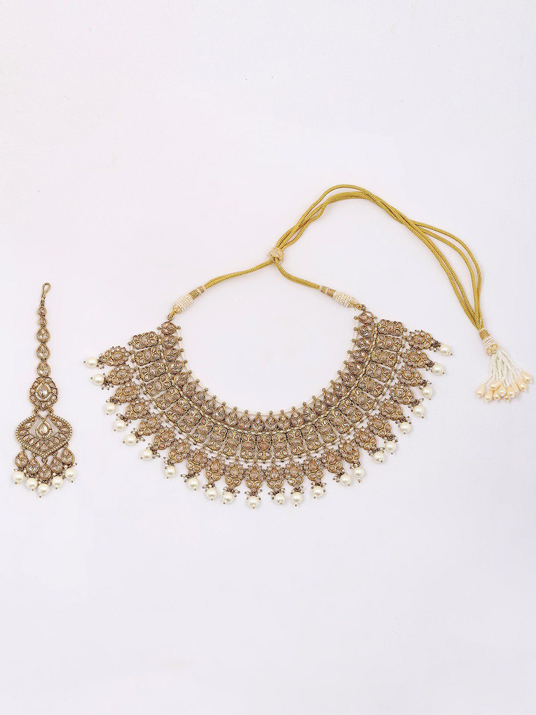 Exotic India Golden And White Stone Studded Brass Necklace Set with Earrings And Mangtika