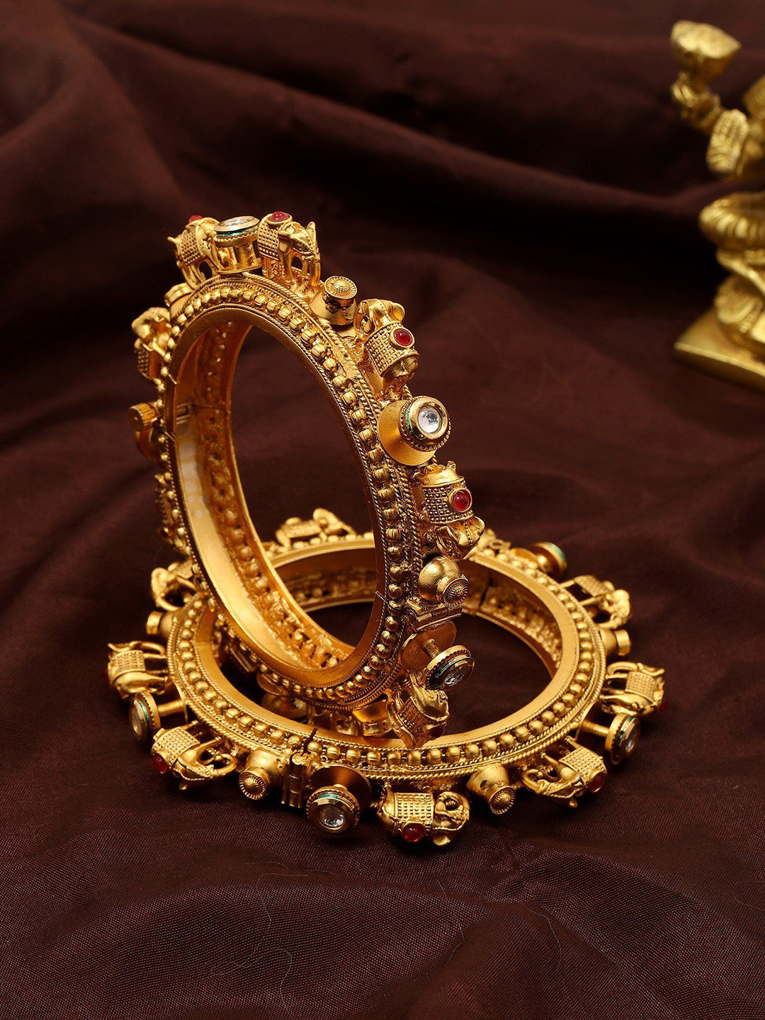 Exotic India Set Of 2 Gold-Plated Elephant Design Stone Studded Pacheli Bangles In Copper