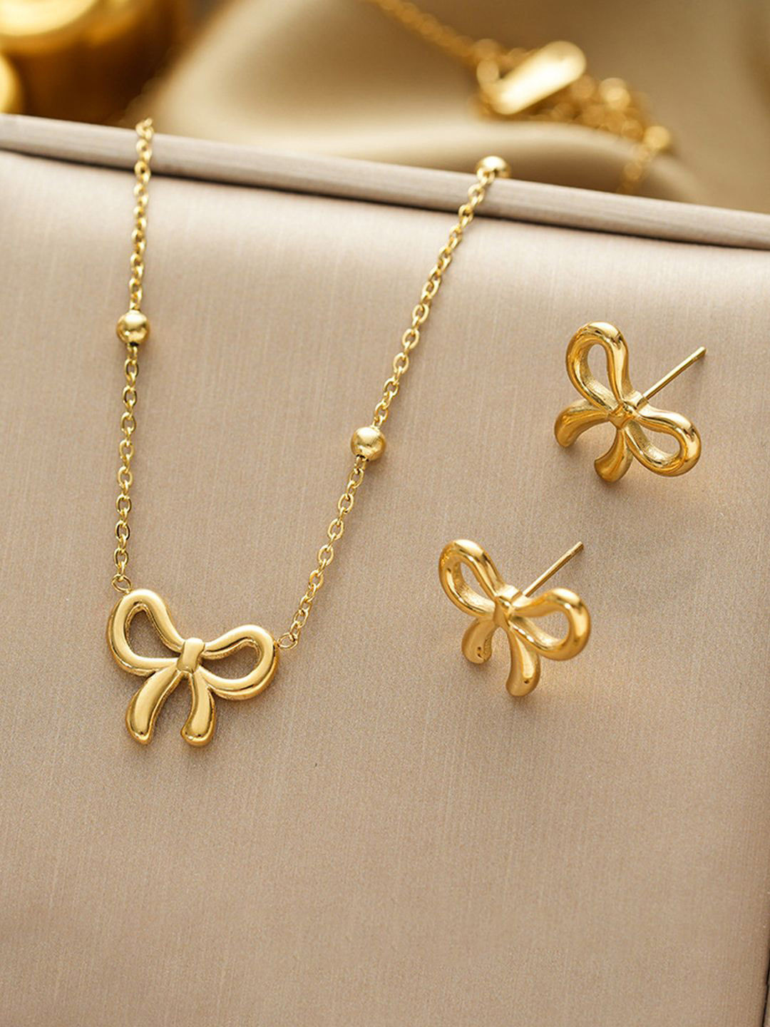 Jewels Galaxy Stainless Steel Gold-Plated Bow Shaped Necklace And Earrings