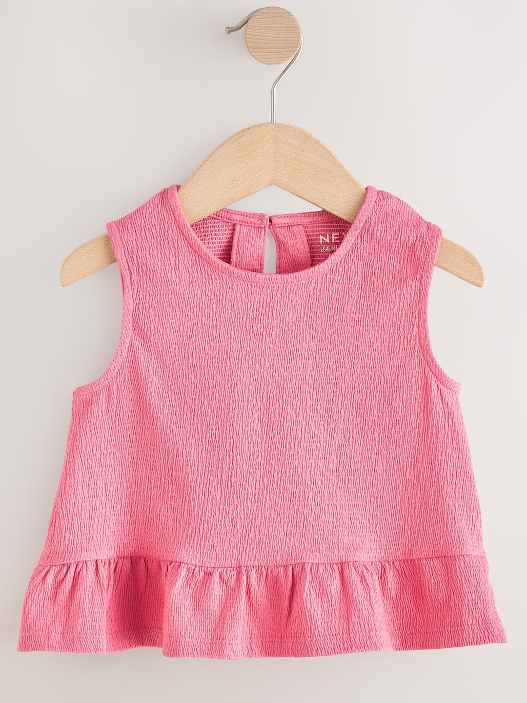 NEXT Textured Peplum Top