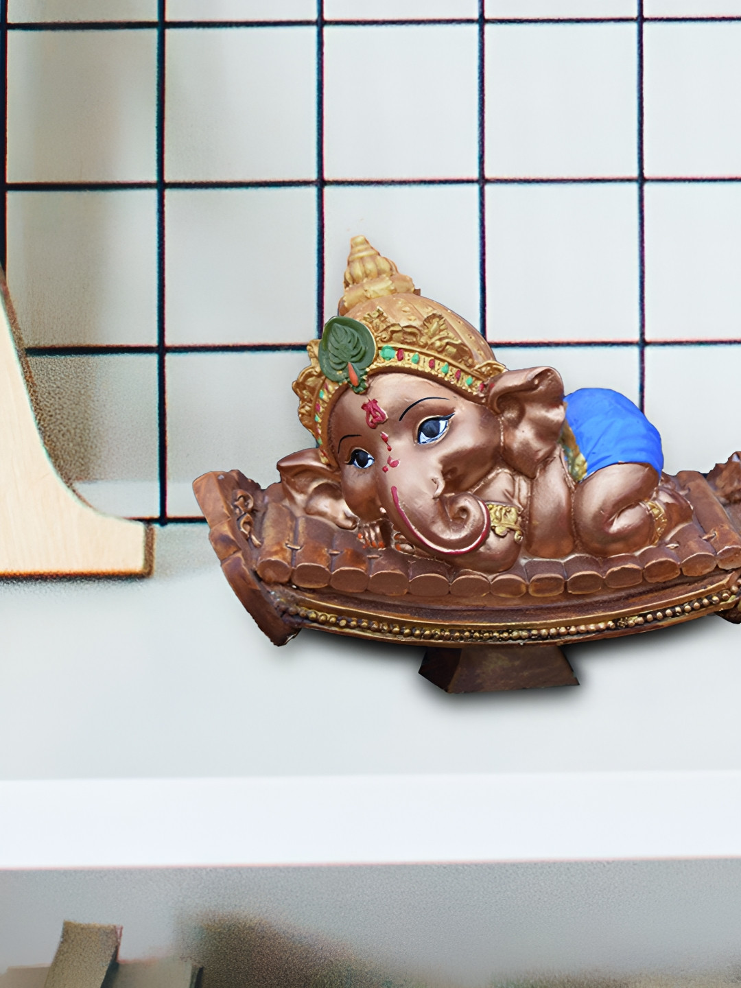Aura Lying Baby Ganesha Brown Polyresin Glossy Prayer Room Small Showpiece - 5.1 Inches