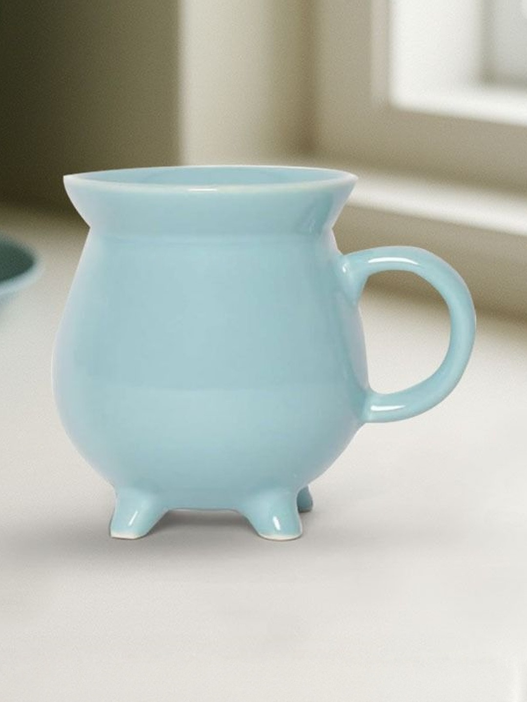 U & U Unique Utilities Sky Blue Glossy Ceramic Coffee Mug With 4 Legs - 340 ml