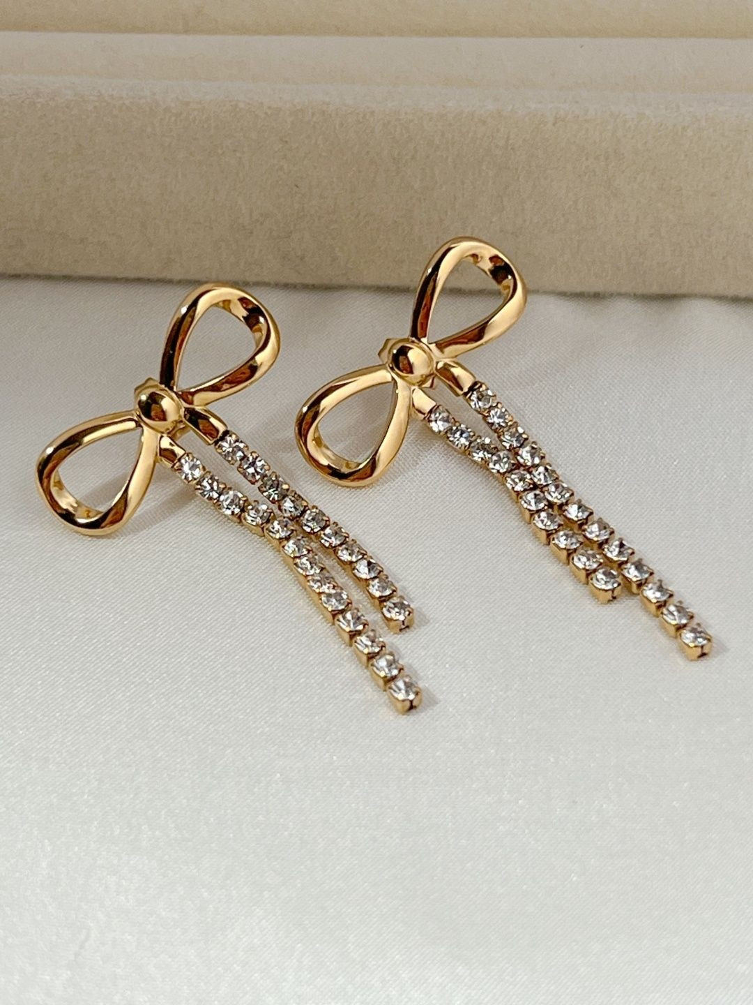 Nam Jewels Stainless Steel Gold-Plated Cubic Zirconia Studded Tasselled Bow Drop Earrings