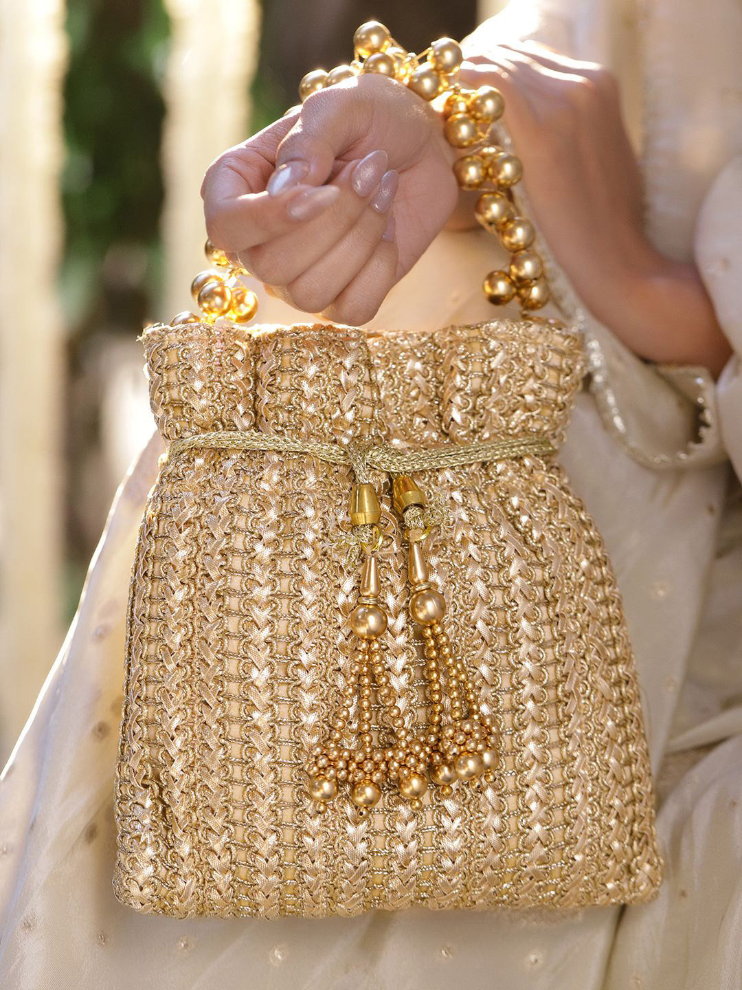 Rubans Gold-Toned Woven Metallic Potli Bag with Golden Bead Handle & Tassel Detailing