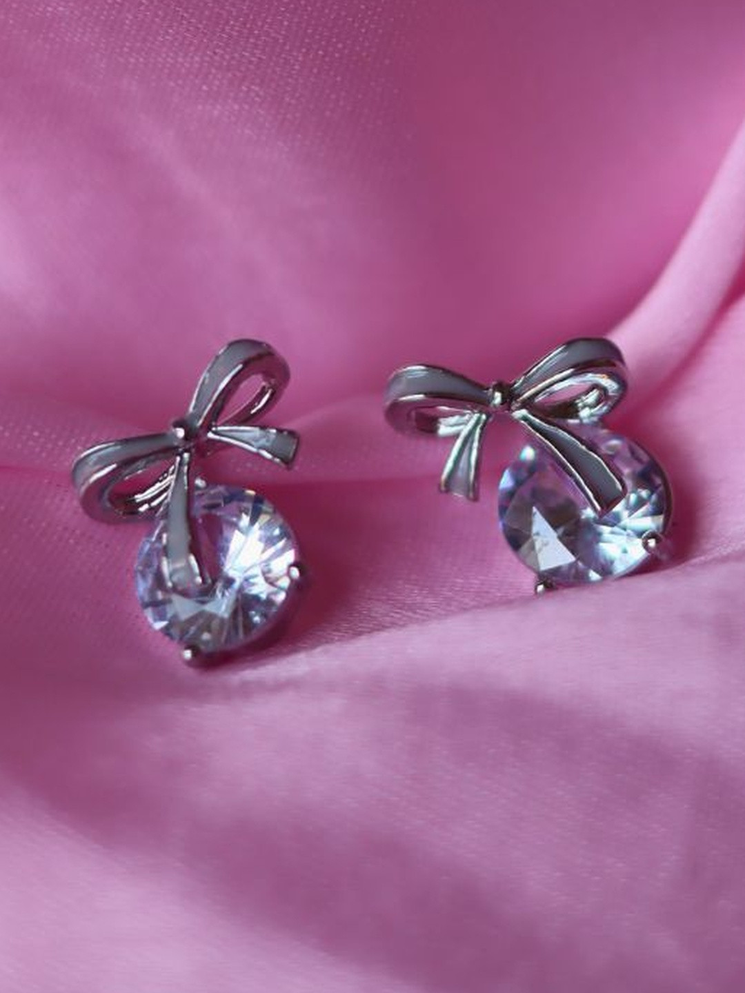 WEAVING HOMES Silver Plated Bow Shaped Studs Artificial Stones Studded Earrings