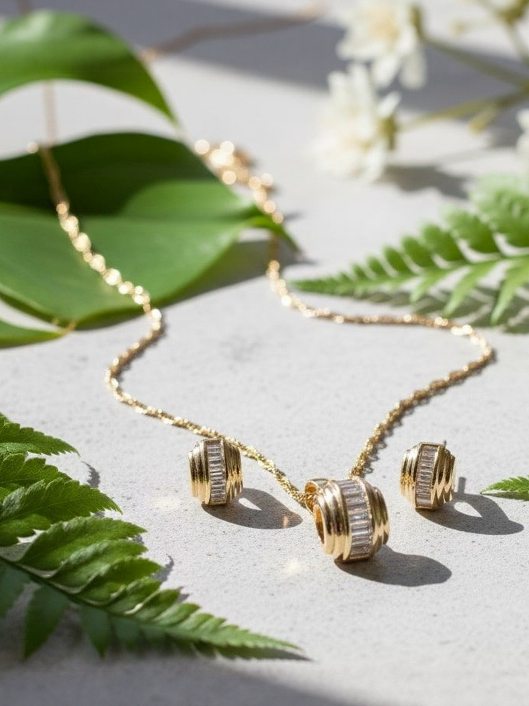 Omkar Jewels Women 18K Gold-Plated American Diamond-Studded Barrel Pendant Jewellery Set