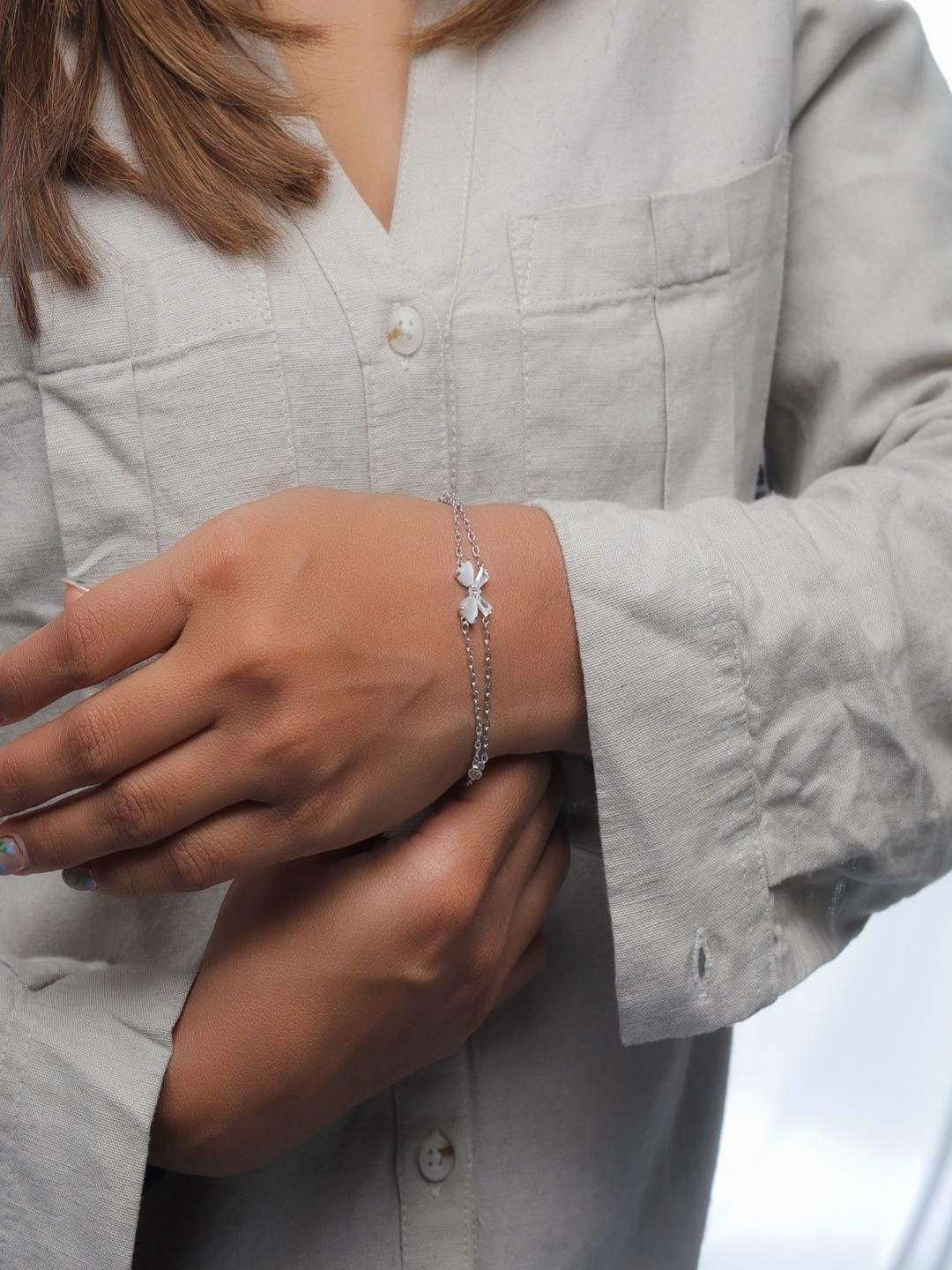 TASSYA Silver Artificial Stones Studded Bow Shaped Link Bracelet