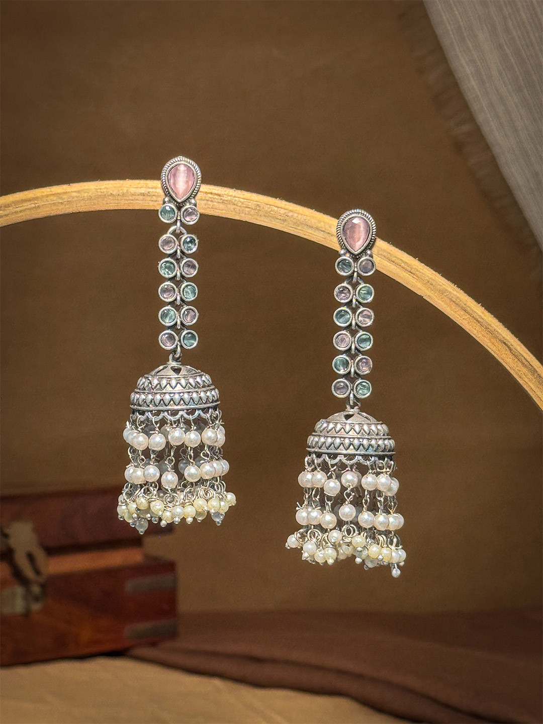 NAMAN ARTS Silver-Plated Artificial Stones Studded & Beaded Oxidised Dome Shaped Jhumkas