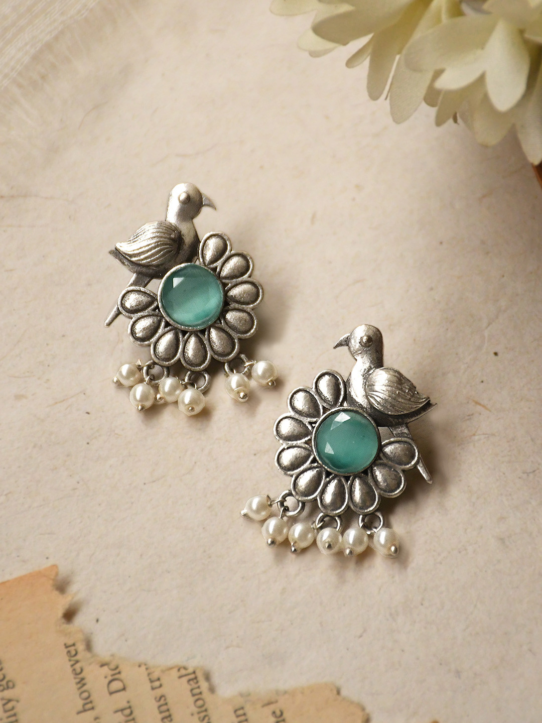 NAMAN ARTS Silver-Plated Stones Studded And Beaded Floral Shaped Oxidised Drop Earrings