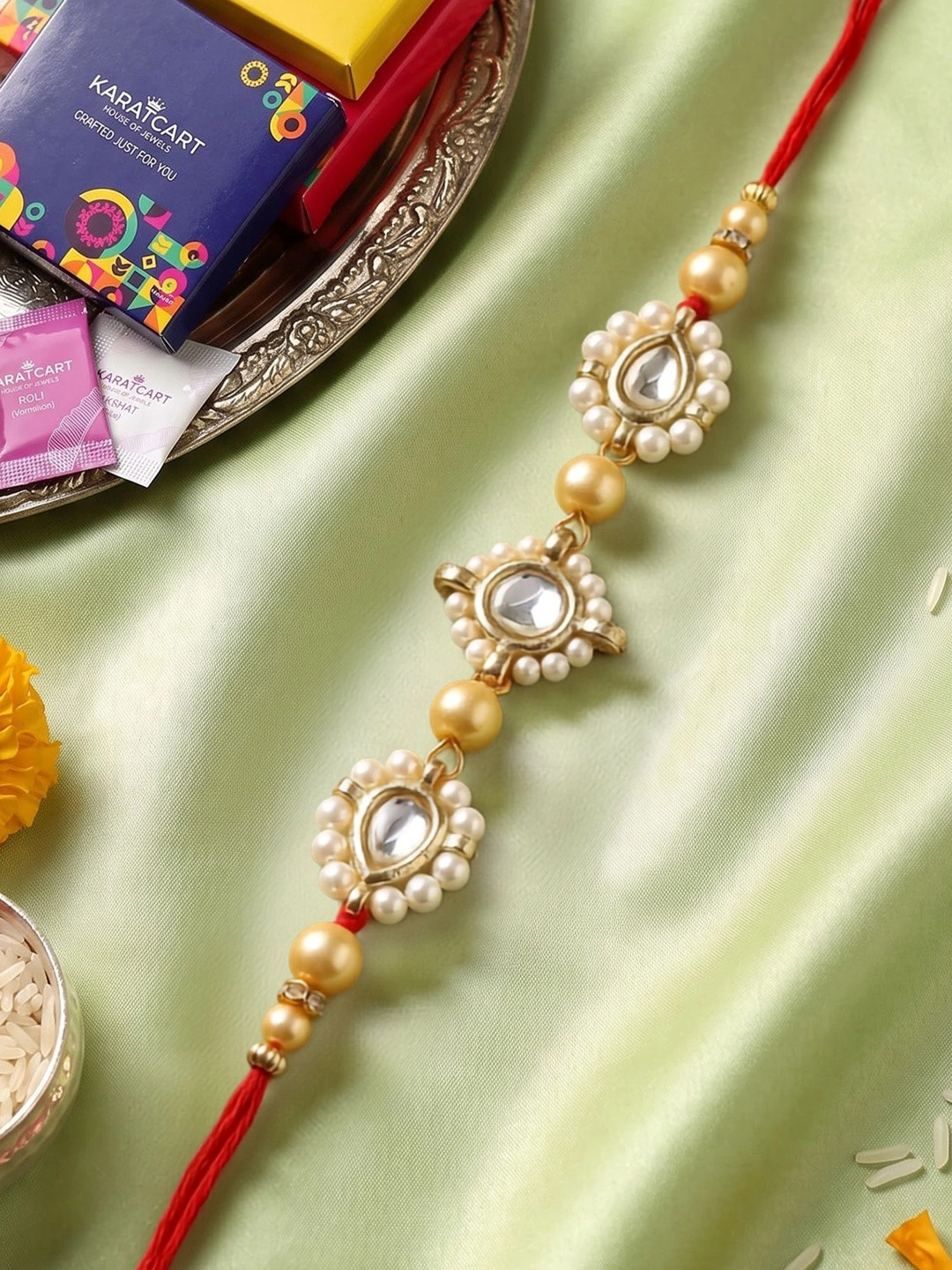 KARATCART Golden Pearls & Kundan Rakhi with Roli & Chawal