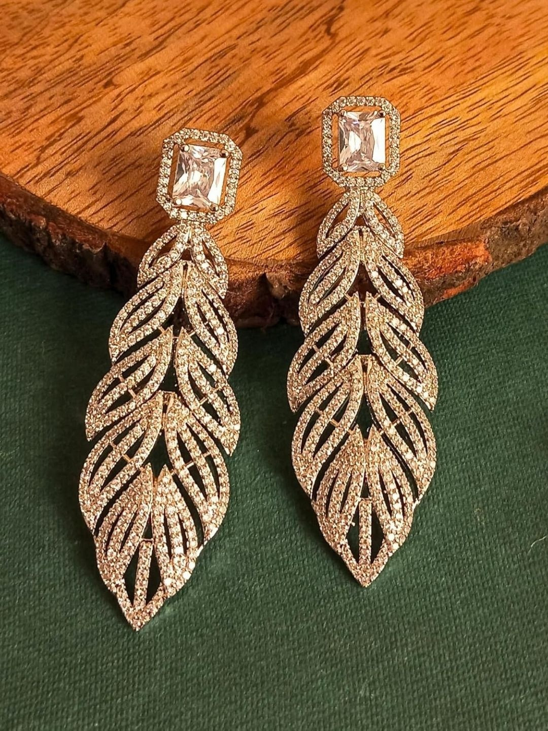 IKSAVA Silver-Plated American Diamond Studded Feather Shaped Drop Earrings