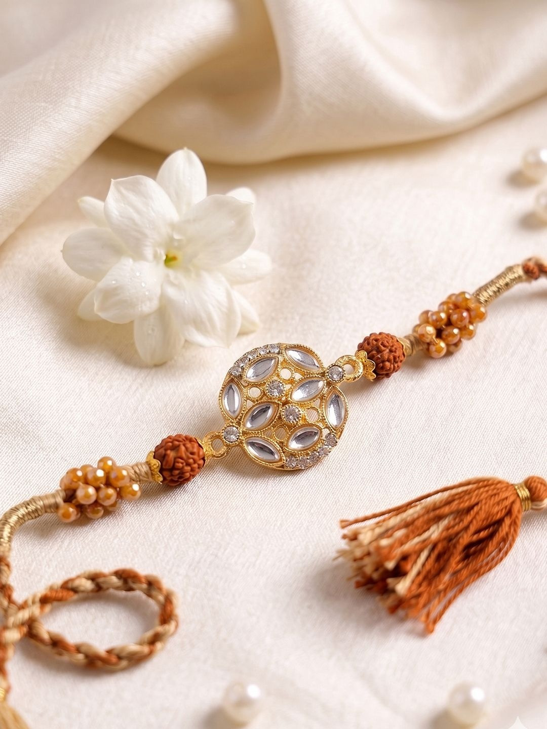 NVR Rudraksh & Kundan Studded Gold Toned Thread Rakhi With Roli Chawal Chandan Mishri