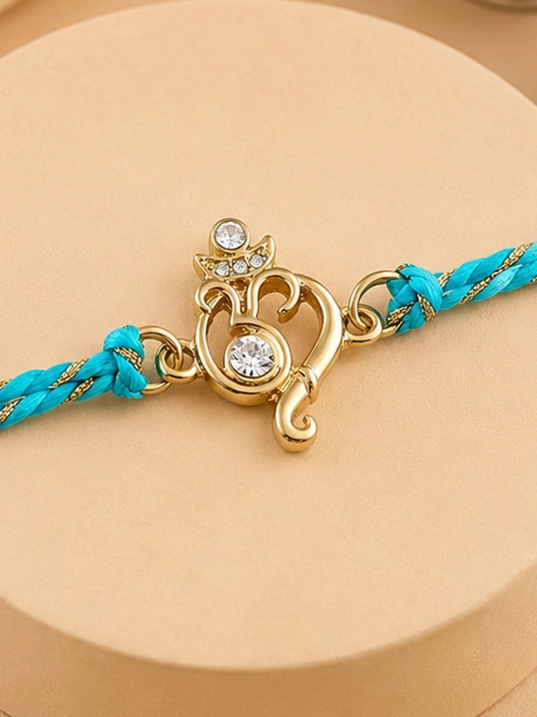 Estele Gold-Plated Crystals-Studded Om Charm Rakhi