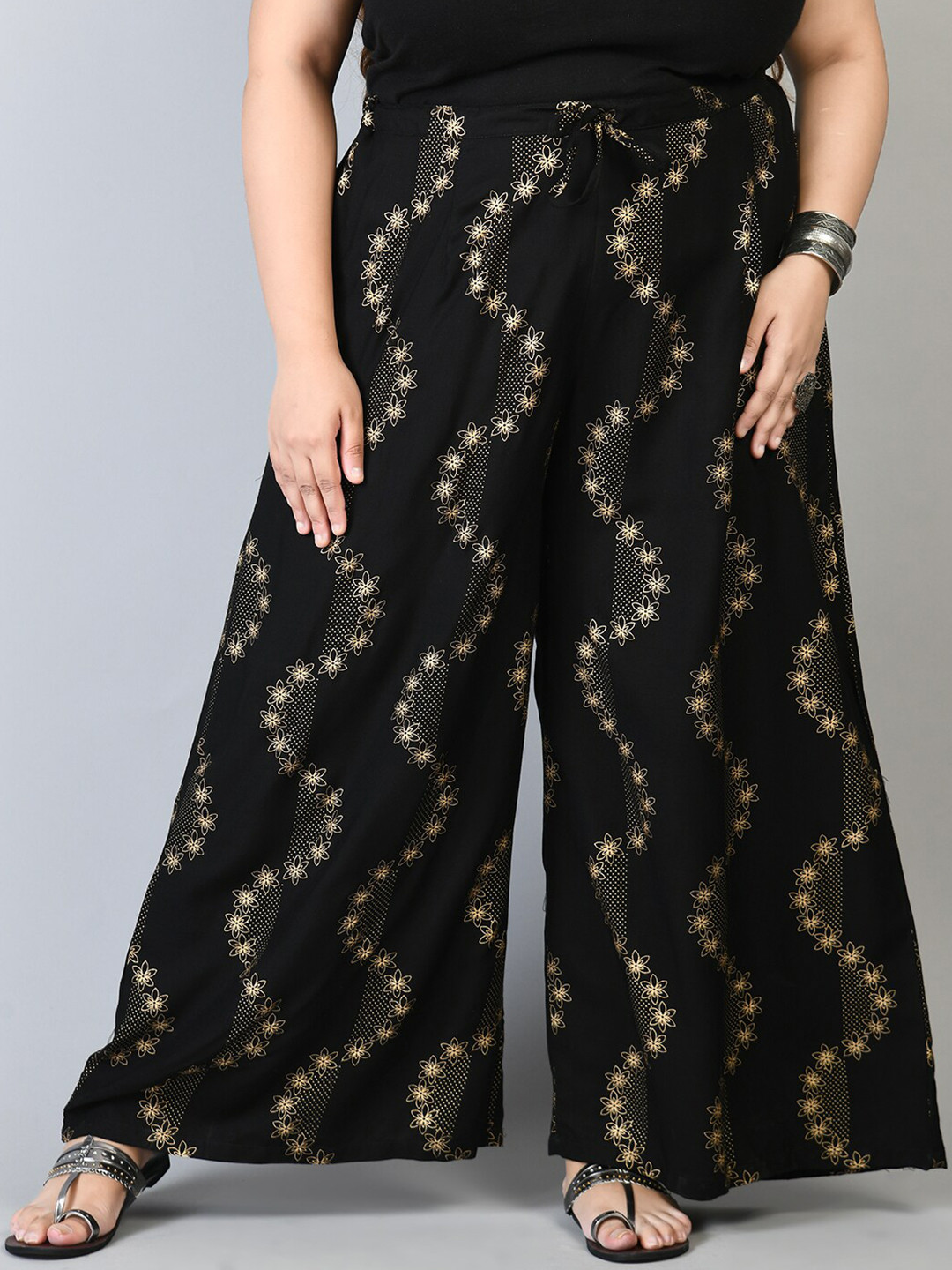 PrettyPlus by Desinoor.com Women Plus Size Black & Gold-Toned Floral Printed Palazzos