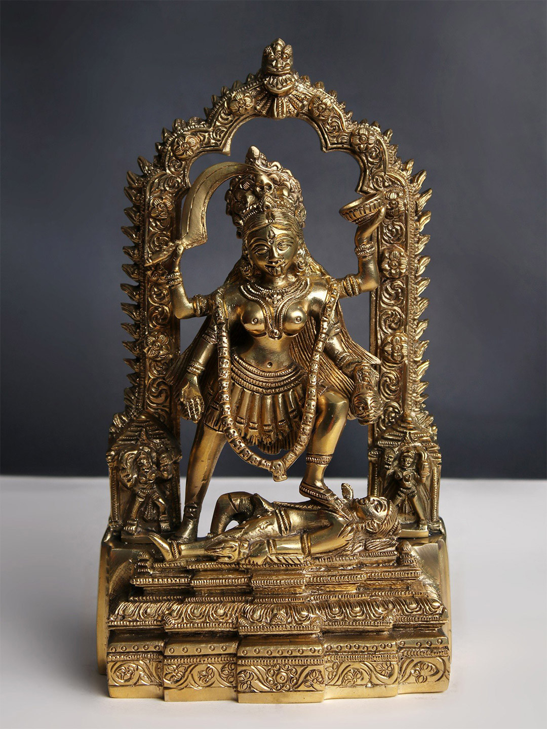 Exotic India Gold-Toned & Brown Brass Goddess Kali with Kirtimukha Showpiece