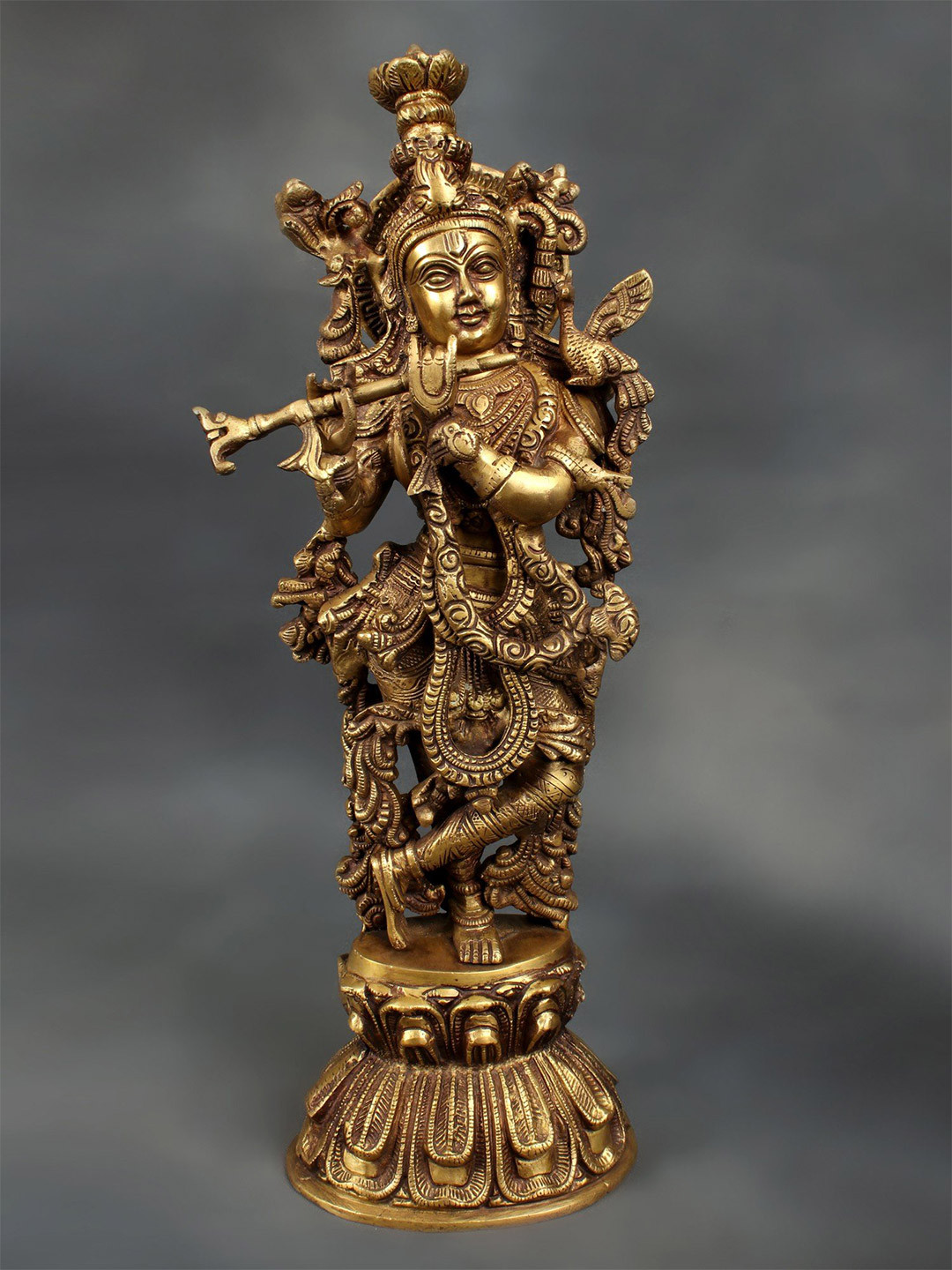 Exotic India Gold Toned Lord Krishna Playing Flute Showpiece