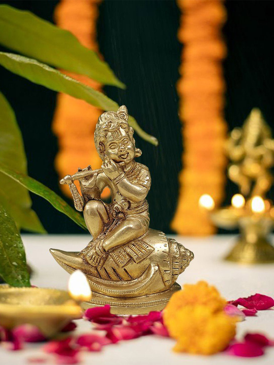 Exotic India Gold Toned Religious Baby Krishna Playing the Flute Idol Showpiece