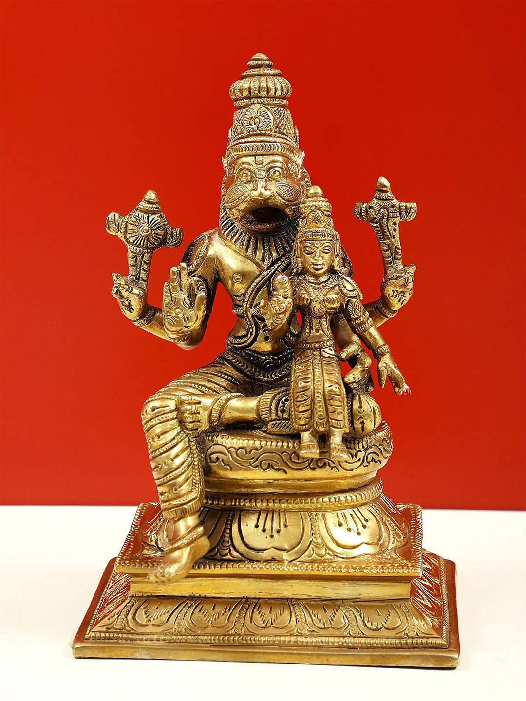 Exotic India Gold Toned Lord Narasimha With Goddess Lakshmi Sitting on Pedestal Showpiece