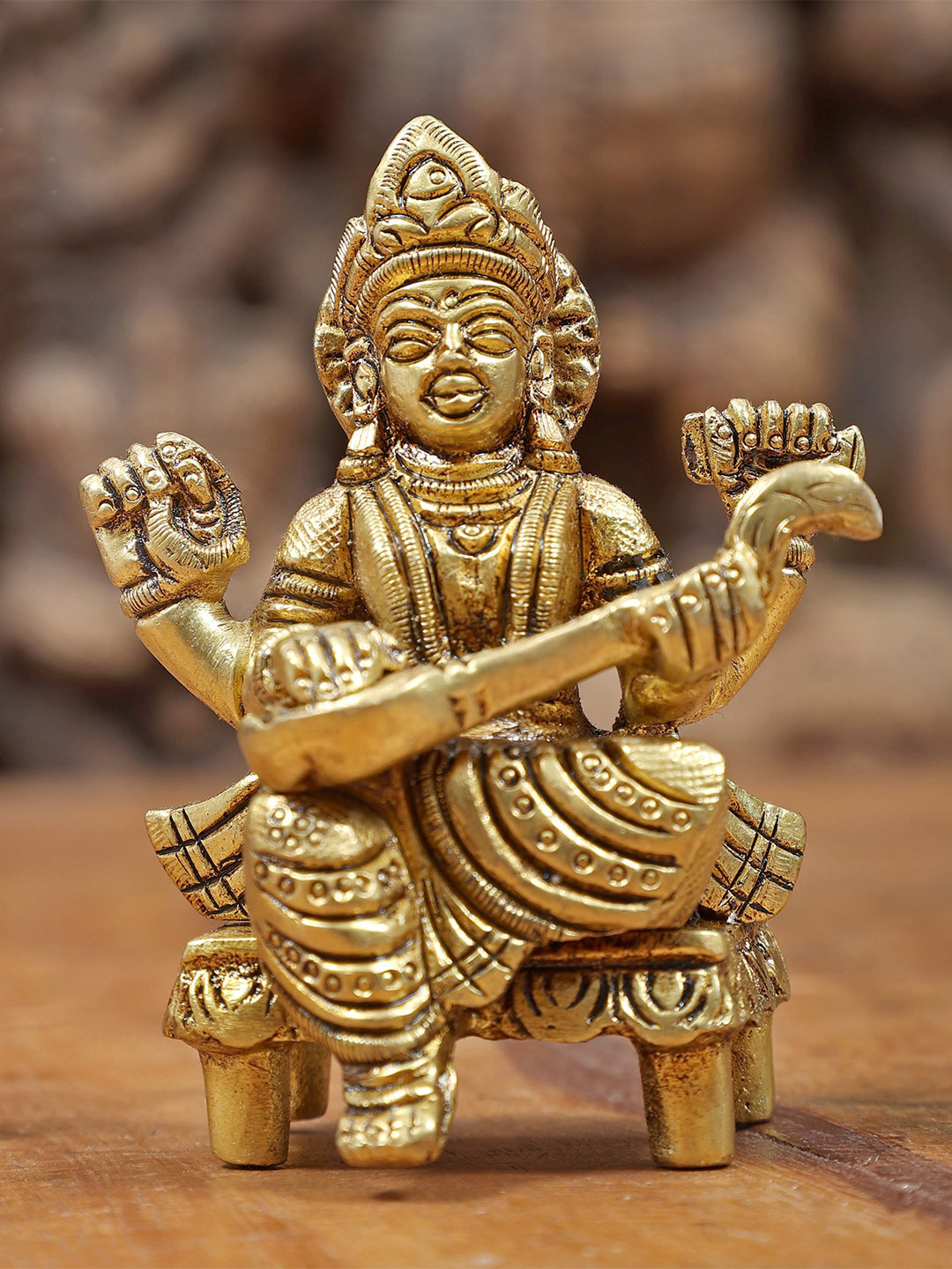 Exotic India Gold-Toned Devi Saraswati Seated On Chowki Religious Showpiece