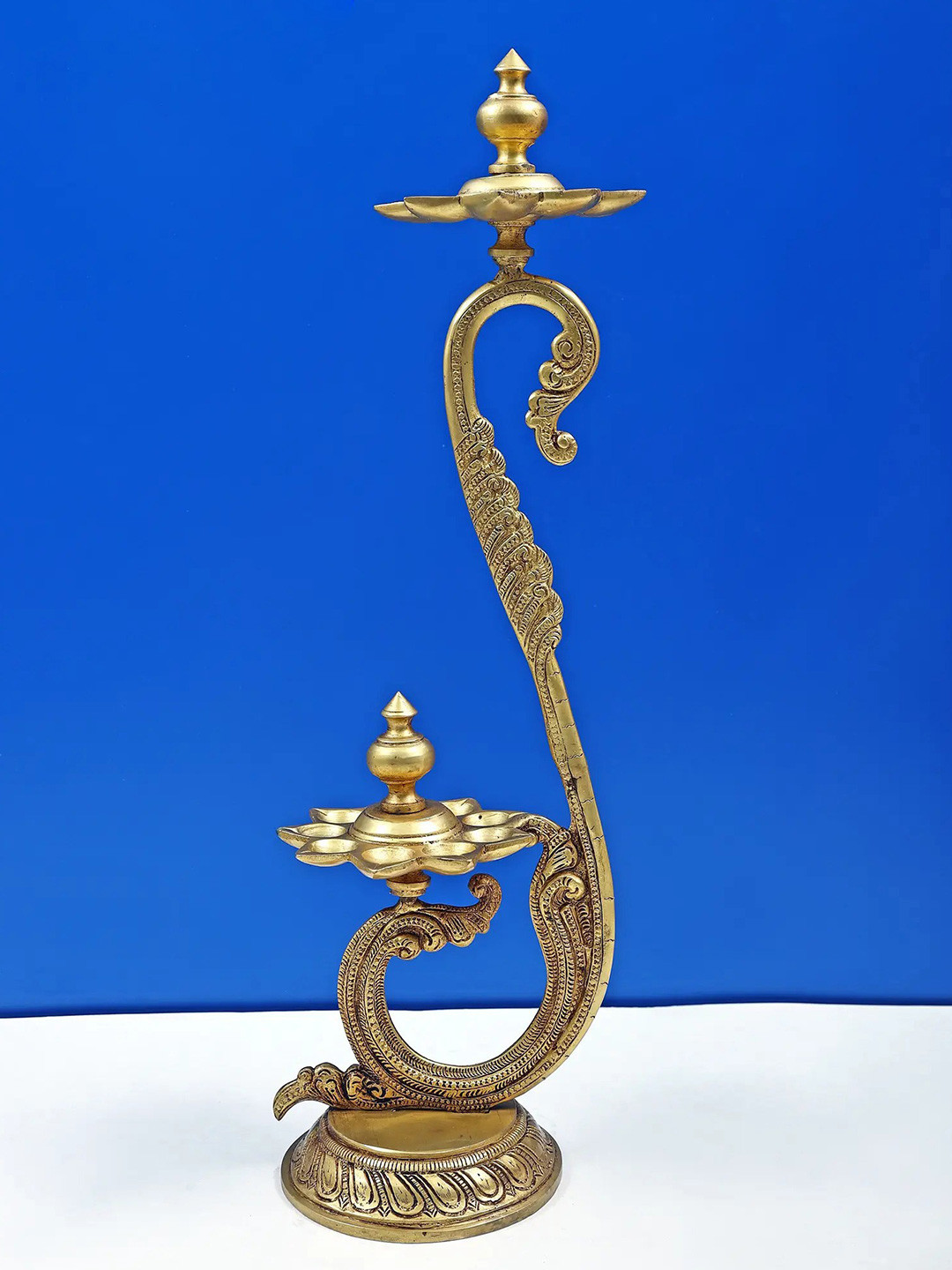 Exotic India Gold-Toned Double Layer Peacock Wicks Lamp Showpiece