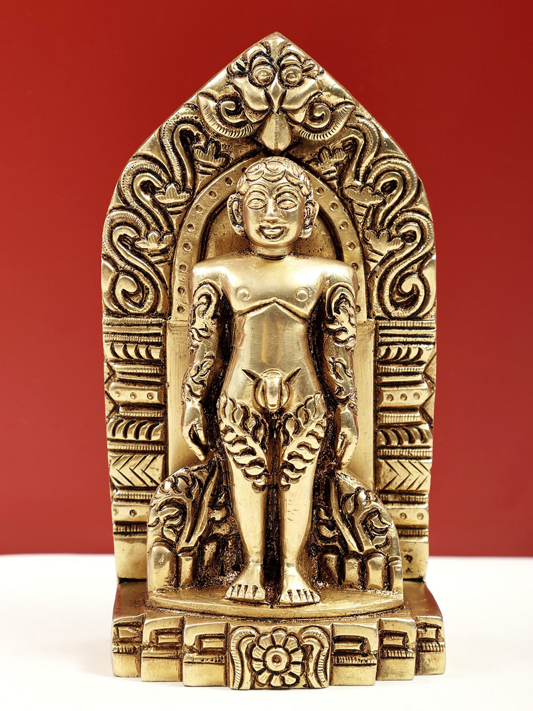 Exotic India Gold-Toned Brass Statue of Bhagawan Mahavir Standing on Kirtimukha Showpiece
