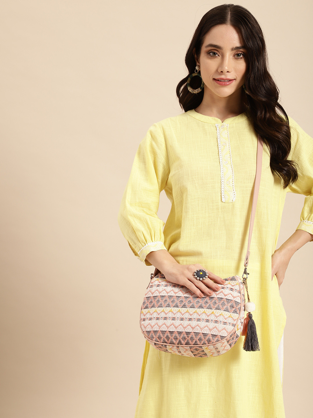 Anouk Textured Self Design Half Moon Sling Bag with Tasselled Detail