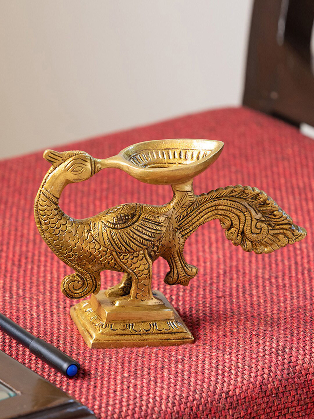 ExclusiveLane Gleaming Gold-Toned Hand-Etched Peacock Carved Diya