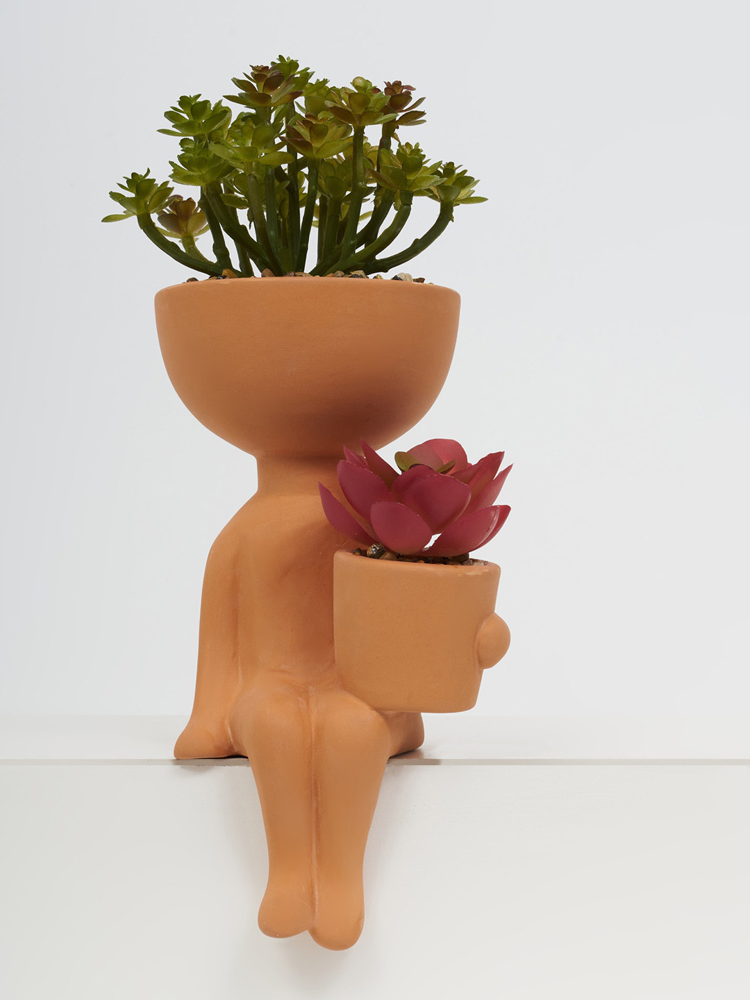 Home Centre Gloria Orange-Colored Human Shaped Ceramic Planter With Artificial Plants