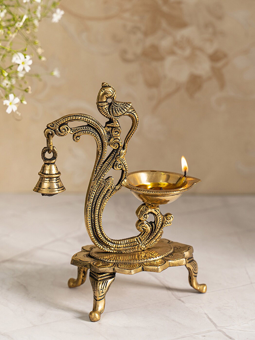 DecorTwist Gold Toned Brass Peacock Diya With Bell