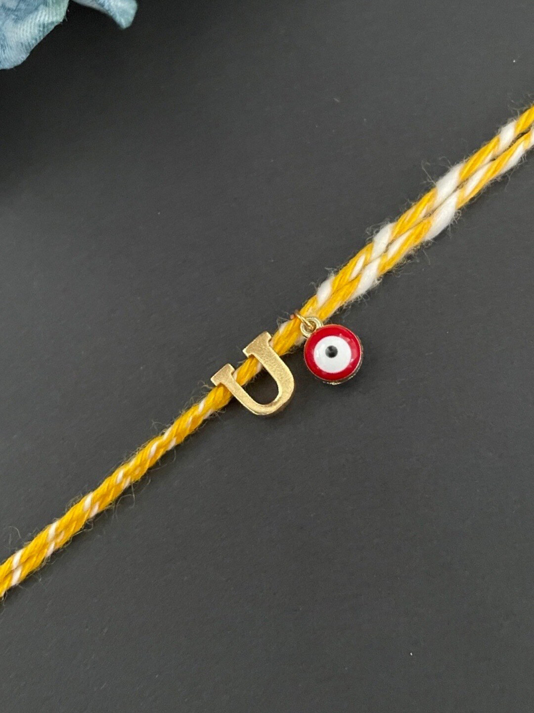 Digital Dress Room Gold-Plated U Alphabet & Evil Eye Charm Rakhi