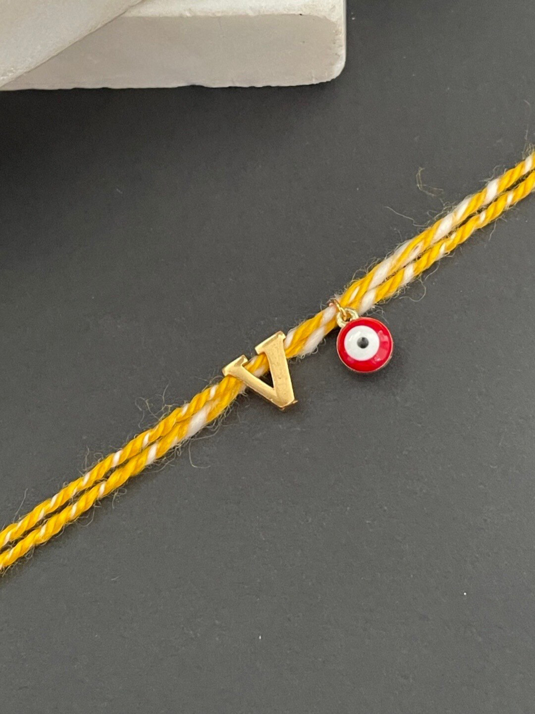 Digital Dress Room Gold-Plated V Alphabet & Evil Eye Charm Rakhi