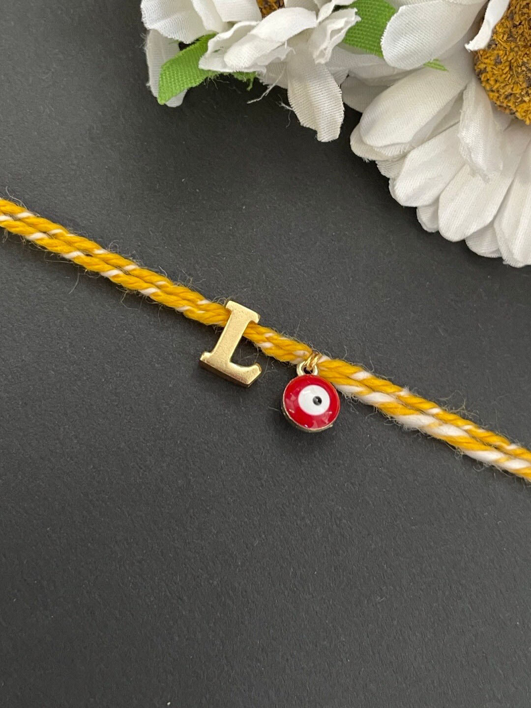 Digital Dress Room Gold-Plated L Alphabet & Evil Eye Charm Rakhi