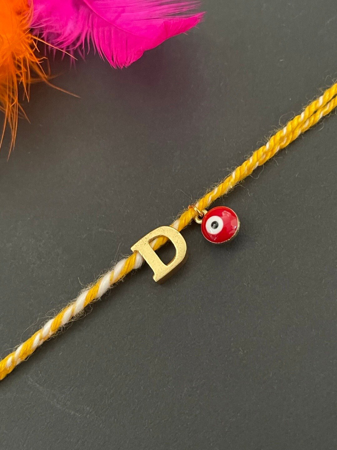 Digital Dress Room Gold-Plated D Alphabet & Evil Eye Charm Rakhi