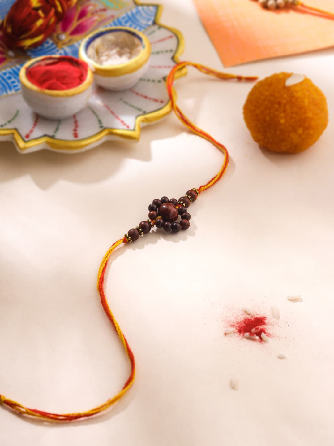 RDK Unisex Flower Beaded Thread Rakhi With Roli & Rice