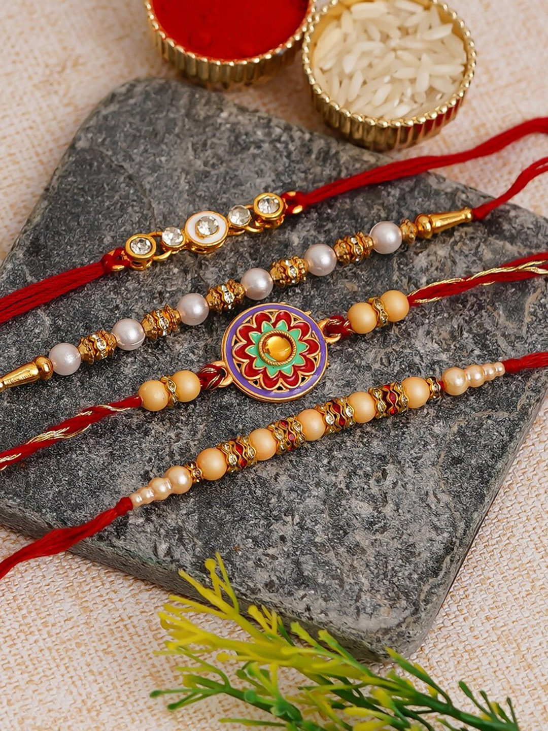 eCraftIndia Unisex Set of 4 Designer Floral Rakhis With 4 Monk Buddha Statues