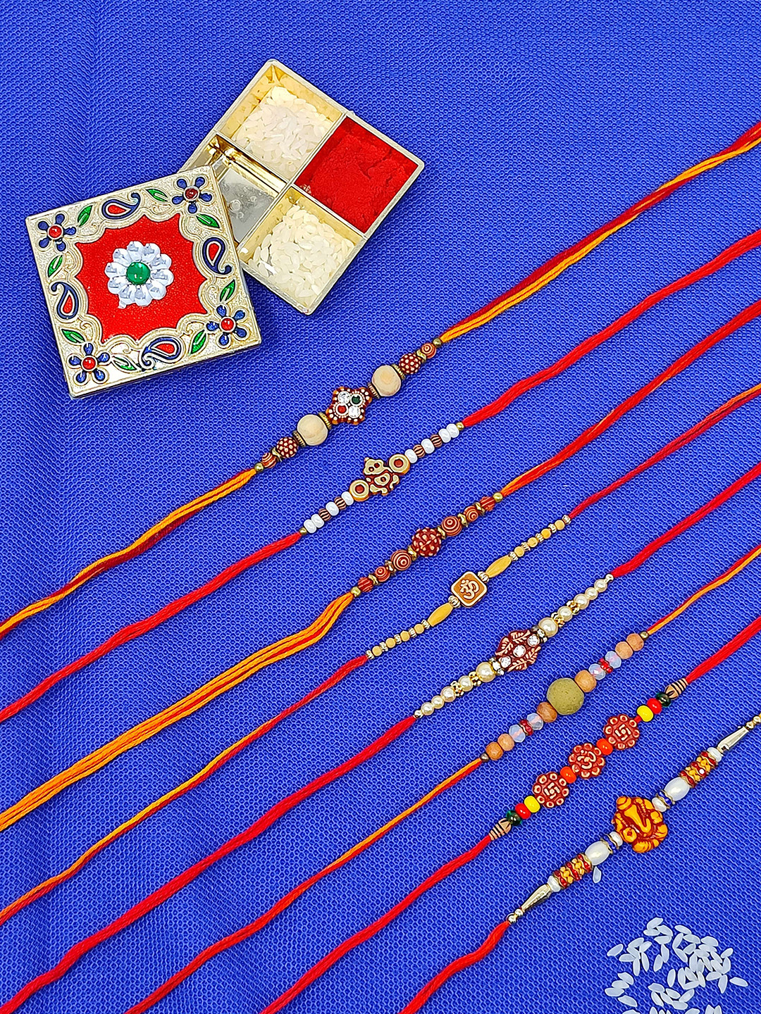 CRAYTON Set of 8 Beaded Thread Rakhis With Roli Chawal Holder
