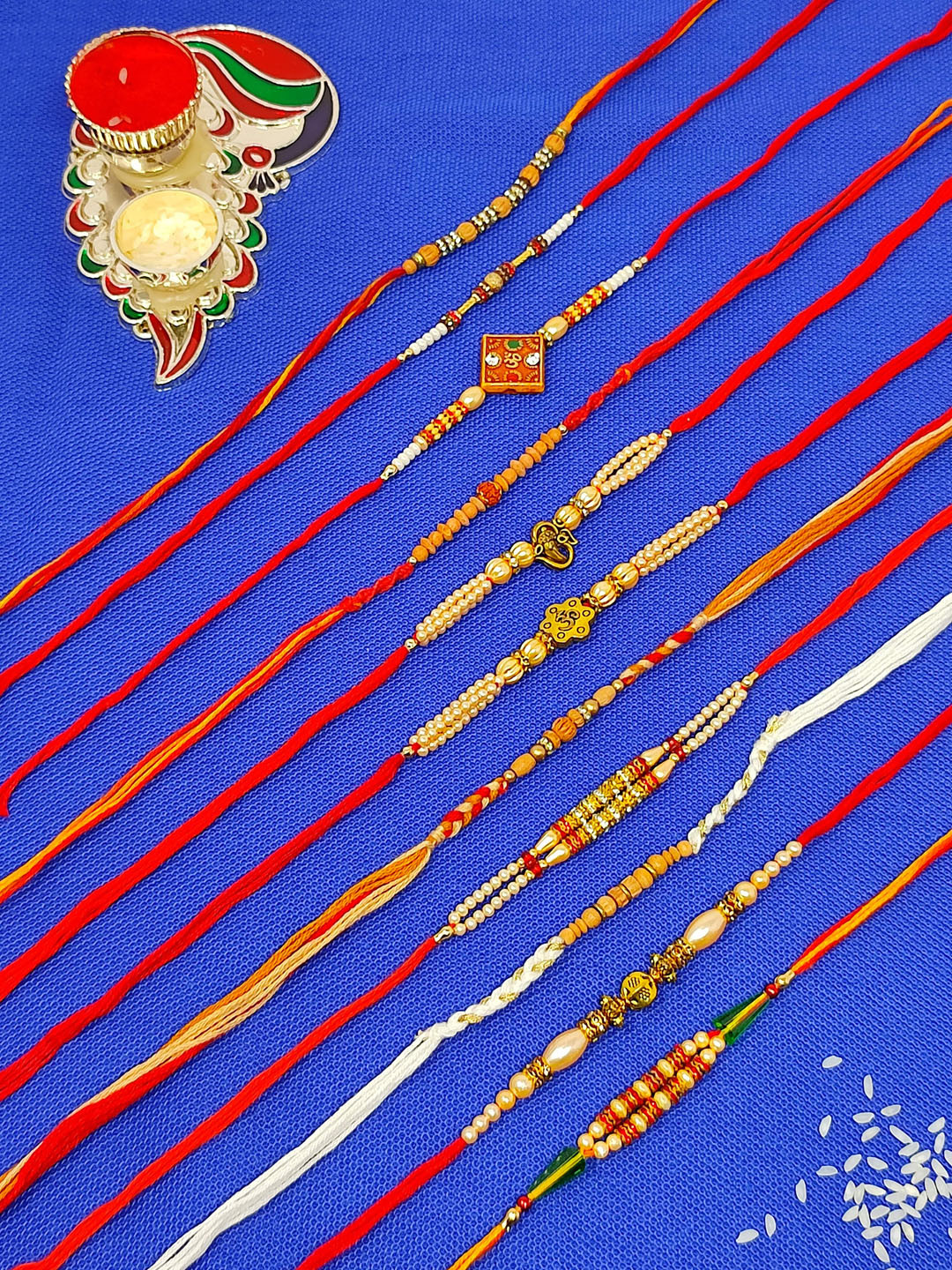 CRAYTON Set of 11 Thread Rakhi with Roli Chaval Holder