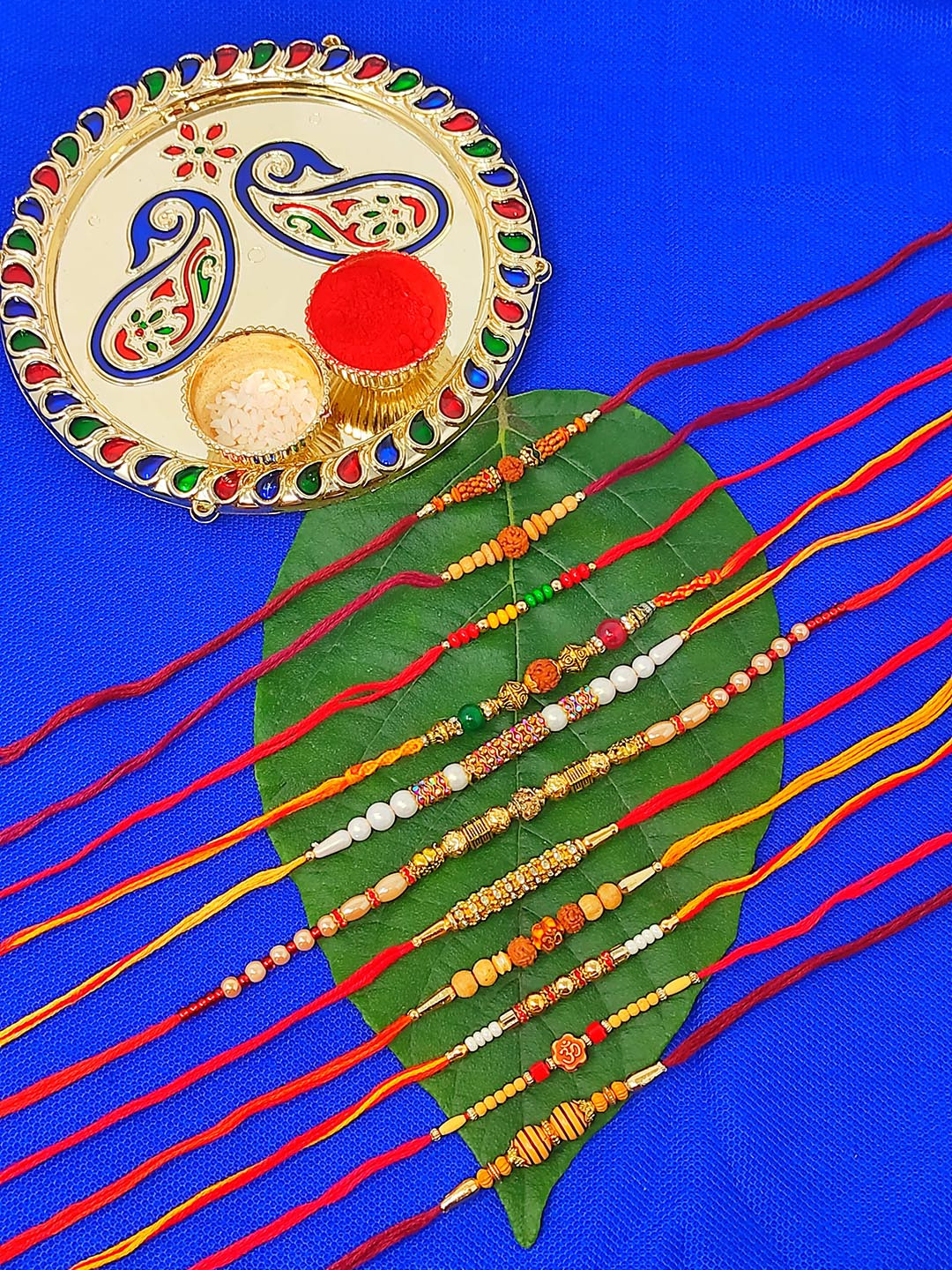 CRAYTON Set of 11 Rakhi With Roli Chaval Holder & Small Plate