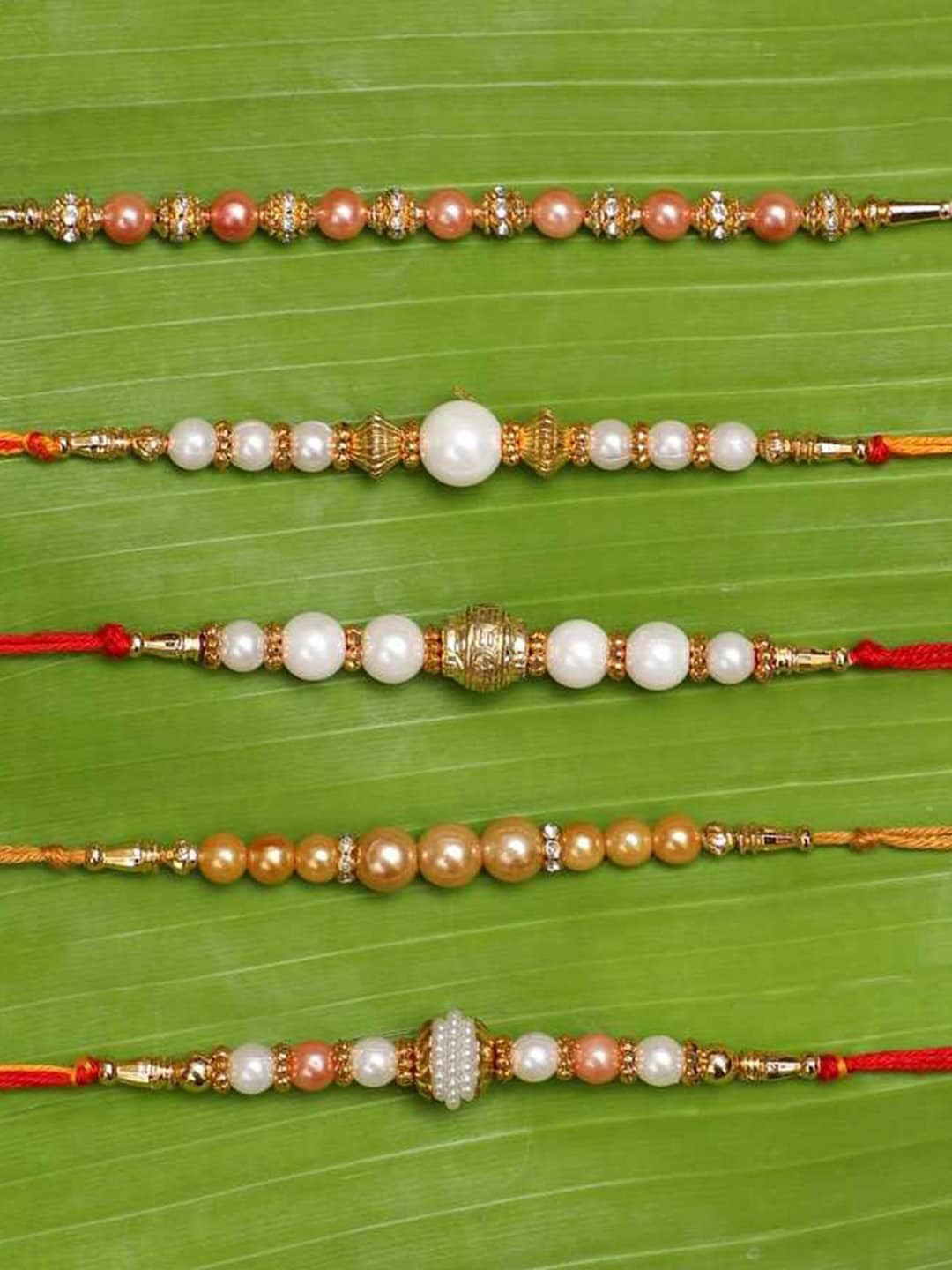 eCraftIndia Set of 5 White & Golden Pearls Rakhis With Roli Chawal Pack