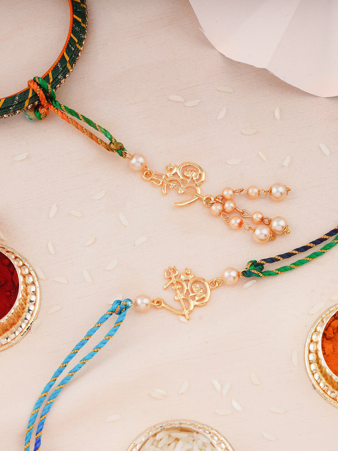 Estele Set Of 2 Om With Trishul Charm Rakhis With Roli Chawal