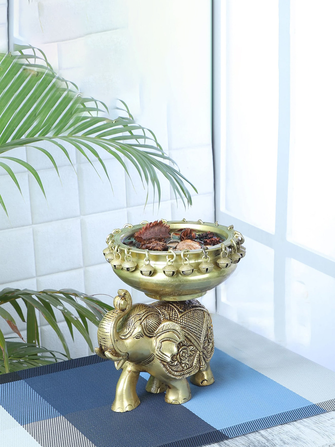 Two Moustaches Gold-Toned Ethnic Design Urli Over Brass Elephant Showpiece