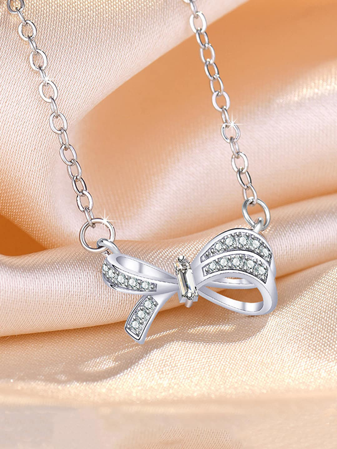Jewels Galaxy Silver-Plated American Diamond-studded Bow-shaped Pendant