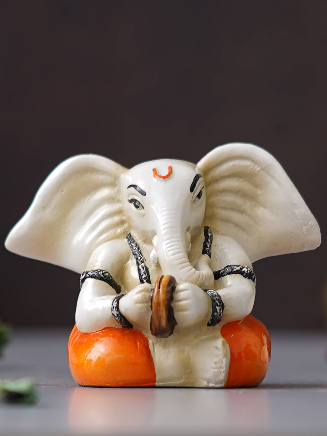 eCraftIndia Lord Ganesha Playing Cymbals Musical instrument Orange Polyresin Glossy Prayer Room Medium Showpiece - 3 Inches