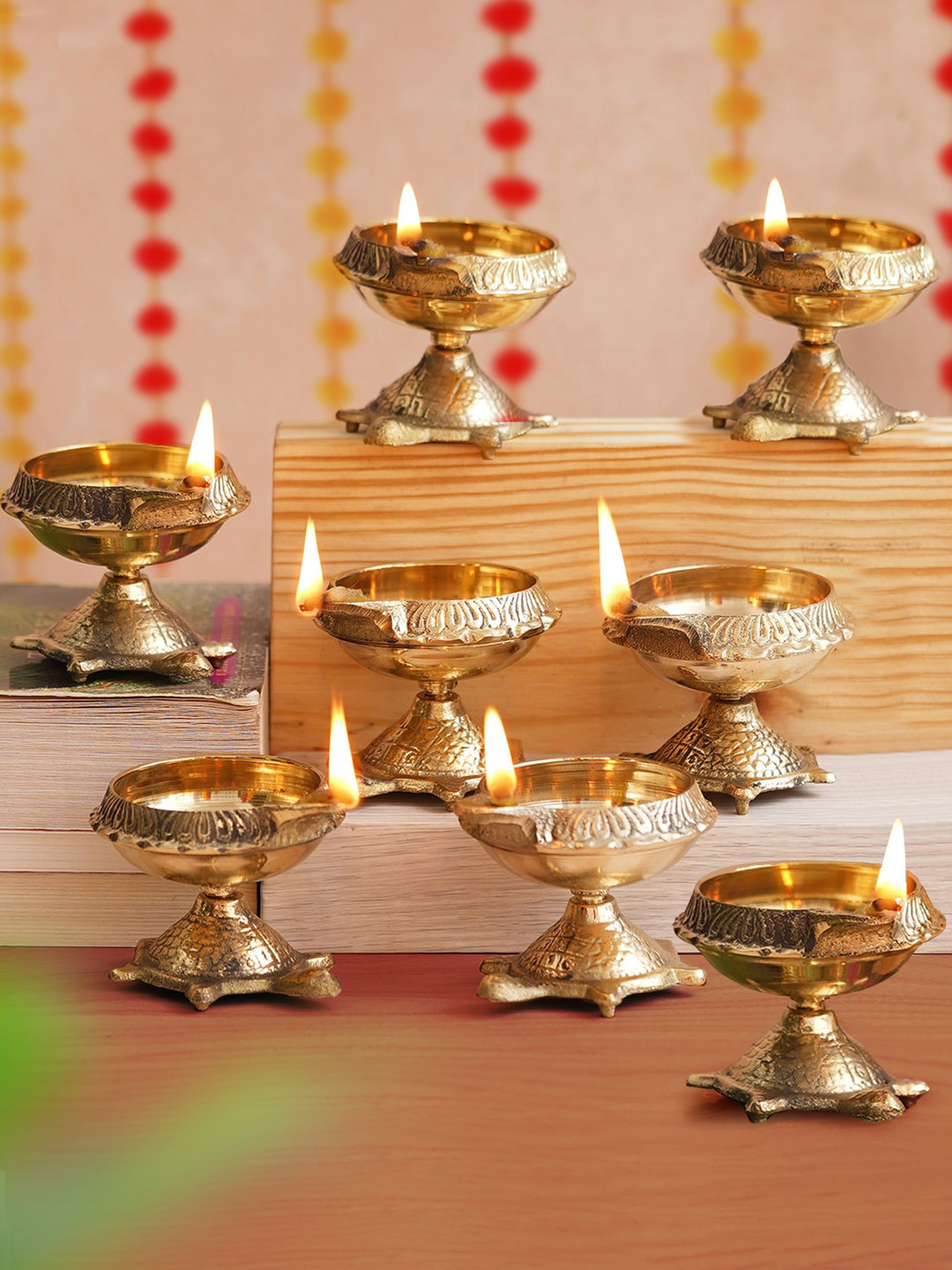 TIED RIBBONS Gold Toned 8 Pieces Decorative Brass Diyas With Tortoise Base
